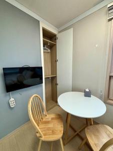 a dining room with a white table and two chairs at Guil Property in Seoul