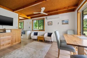 a kitchen and dining room with a table and chairs at Kalamunda 6 - On the Rail Trail in Bright