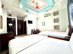 Un pat sau paturi într-o cameră la khách sạn Kim Long