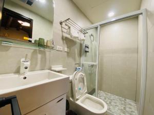 a bathroom with a sink and a toilet and a shower at Wuzou Guesthouse in Jinsha
