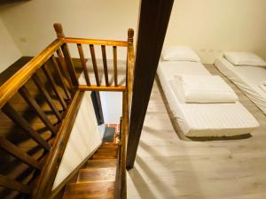 a bedroom with a bunk bed and a staircase at Wuzou Guesthouse in Jinsha