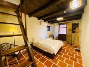 a bedroom with a bunk bed and a ladder at Wuzou Guesthouse in Jinsha