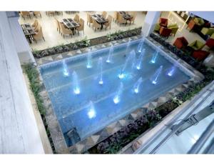 ein Schwimmbad mit Lichtern in der Mitte eines Gebäudes in der Unterkunft Royal Park Resorts, Zirakpur, PB in Zirakpur