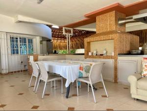 a kitchen with a table and chairs in a room at Amazing 5BR House with Ocean View in Cartagena in Playa Blanca