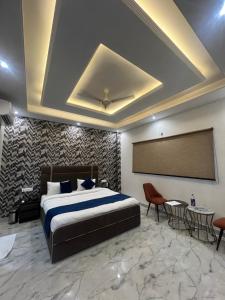 a bedroom with a bed and a projection screen at Crescent Inn in Greater Noida