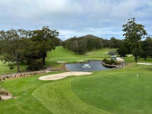 an aerial view of a golf course with a pond at Tomaree Townhouse 5 large air conditioned townhouse and WI-FI in Nelson Bay