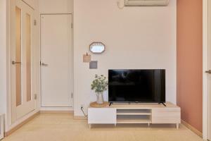 a living room with a flat screen tv on a cabinet at It’ ta de MORRIS/RETRO in Osaka