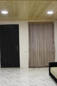 Hostel in Katskhi في Katsʼkhi: غرفة بها باب أسود ونافذة