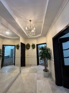 a large hallway with a chandelier and a hallway with a hallway sidx sidx at فيلا سكنية فاخرة in AlUla
