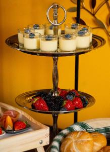 a tiered plate of food with fruit and candles at Villa Gottfried B&B in Eggen