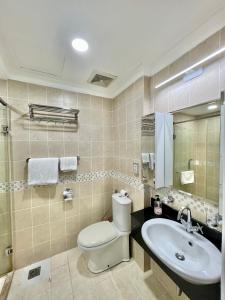 a bathroom with a toilet and a sink at Diny ApartHotel - Rooftop Pool - The Manor 2 in Ho Chi Minh City
