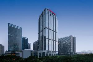 a tall building in a city with many skyscrapers at Hampton by Hilton Foshan Beijiao in Foshan