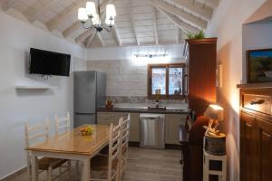 a kitchen with a wooden table and a dining room at Casa Sophie by Huskalia - private pool in Los Llanos de Aridane