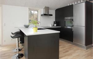 a kitchen with a white counter and a refrigerator at Nice Home In Haderslev With Wifi in Kelstrup Strand