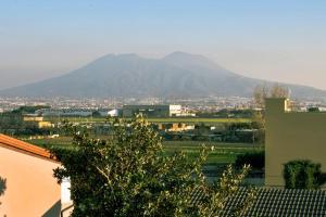 Vue sur une ville avec une montagne en arrière-plan dans l'établissement Grazioso Appartamento Aeroporto, à Naples