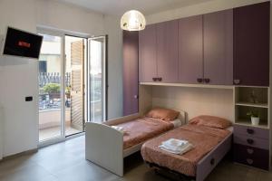 - une chambre avec un lit et des placards violets dans l'établissement Grazioso Appartamento Aeroporto, à Naples