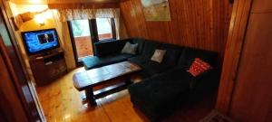 a living room with a couch and a coffee table at Domek Brenna in Brenna