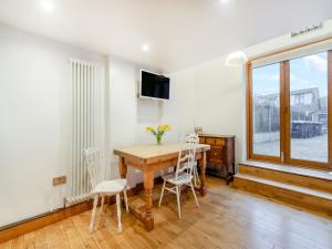 a dining room with a wooden table and chairs at Little Batley House in Westgate-on-Sea