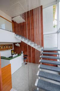 a staircase in a house with a glass wall at HOTEL VARDHA Inn in Bhavāni