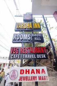 a group of signs on the side of a building at HOTEL VARDHA Inn in Bhavāni