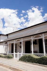 a white building with a white fence and a sky at Knus Richmond in Richmond