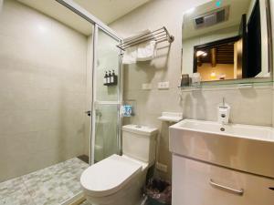 a bathroom with a toilet and a sink and a shower at Wuzou Guesthouse in Jinsha