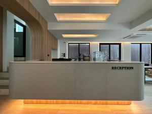 a lobby with a reception desk in a building at Jace hotel in Bangkok