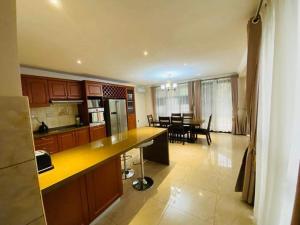 a kitchen with a table and a dining room at Marangu (3bedroom) in Lusaka