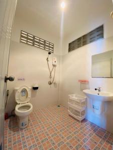 a bathroom with a toilet and a sink at Elephant bungalow at Ya Nui beach in Phuket