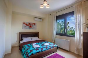 a bedroom with a bed and a window at Perfect view Villa Deny with 6 bedrooms and heated pool in Hanioti