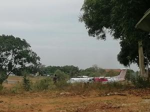 a plane is parked in a field with trees at MAGNOLIA SUITES in Ukunda