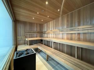 a sauna with wooden benches in a room at Collins Serviced Apartments in Melbourne