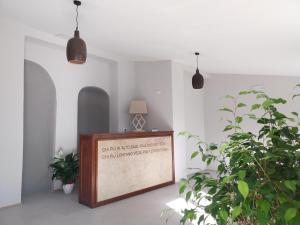 a framed sign in a room with potted plants at Affittacamere Ellera Verde in Villetta Barrea