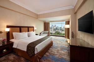 Tempat tidur dalam kamar di Lumire Hotel & Convention Centre