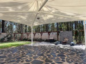 a large white tent with a fireplace in a yard at Villa Provence in Pokolbin