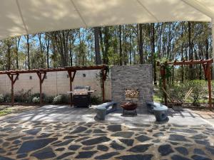 a patio with two toilets and a fire place at Villa Provence in Pokolbin