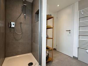 a bathroom with a shower with a tub and a sink at Wohnen auf der historischen Stadtmauer im Herzen von Detmold in Detmold +26 photos