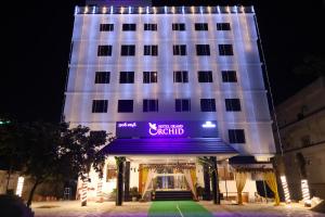 a lit up building with a sign on it at HOTEL GRAND ORCHID in Tirupati