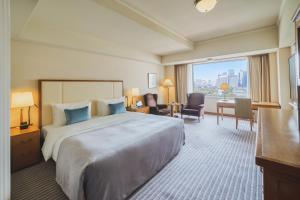 a hotel room with a large bed and a large window at Imperial Hotel Tokyo in Tokyo