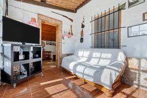a bedroom with a bed and a flat screen tv at Villa Fina in Deltebre