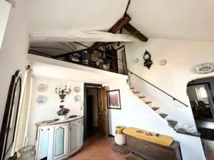 a hallway with a staircase in a house at Casa Parasio 1700 in Imperia