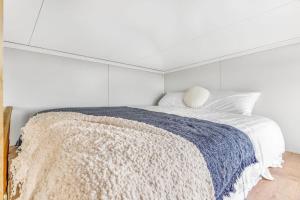 a white bedroom with a bed with a blue blanket at Montara Views 3 in Ararat