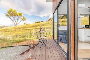 a room with a view of a field from a house at Montara Views 3 in Ararat