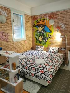 a bedroom with a bed with a painting on the wall at Street Art Suite in Zagreb