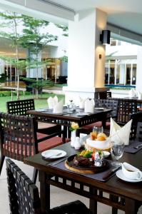 a table with a plate of food on it at Kantary Hills Hotel, Chiang Mai in Chiang Mai