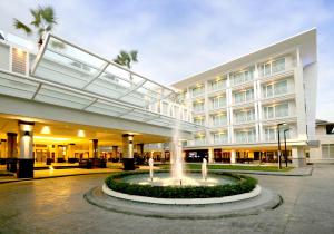 a large building with a fountain in front of it at Kantary Hills Hotel, Chiang Mai in Chiang Mai