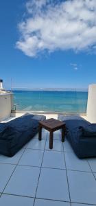 a table in a room with a view of the ocean at Almare Beach Hotel in Kokkini Khanion