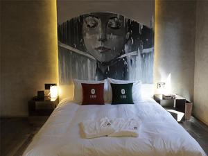 a bedroom with a bed with a picture of a woman at Luo Hotel in Daegu