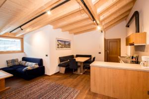 a living room with a couch and a table at App. Erta - Ciasa Lavarella in San Vigilio Di Marebbe