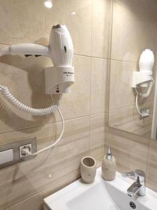 a bathroom with a white sink and a mirror at Charming house in Biescas with shared pool in Biescas
